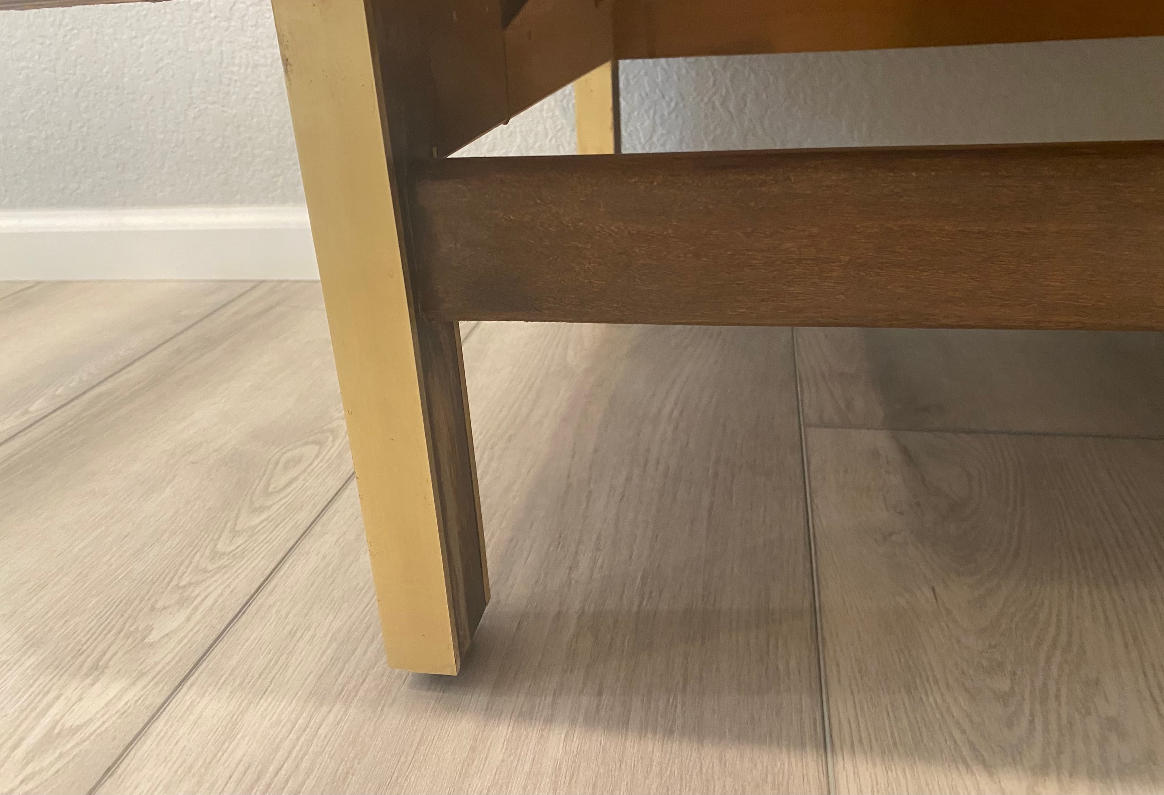 Close detail of walnut leg joinery.